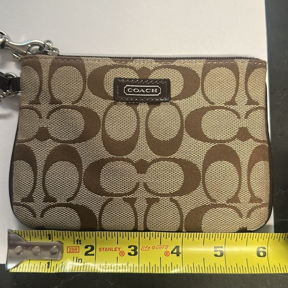 COACH wristlet 6x4 inches in size.  Inside is in great condition.  Tan/brown - Picture 2 of 3